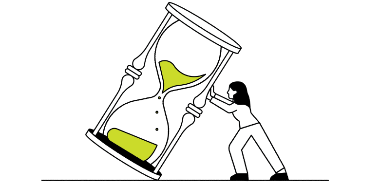 Person turning over a large hourglass