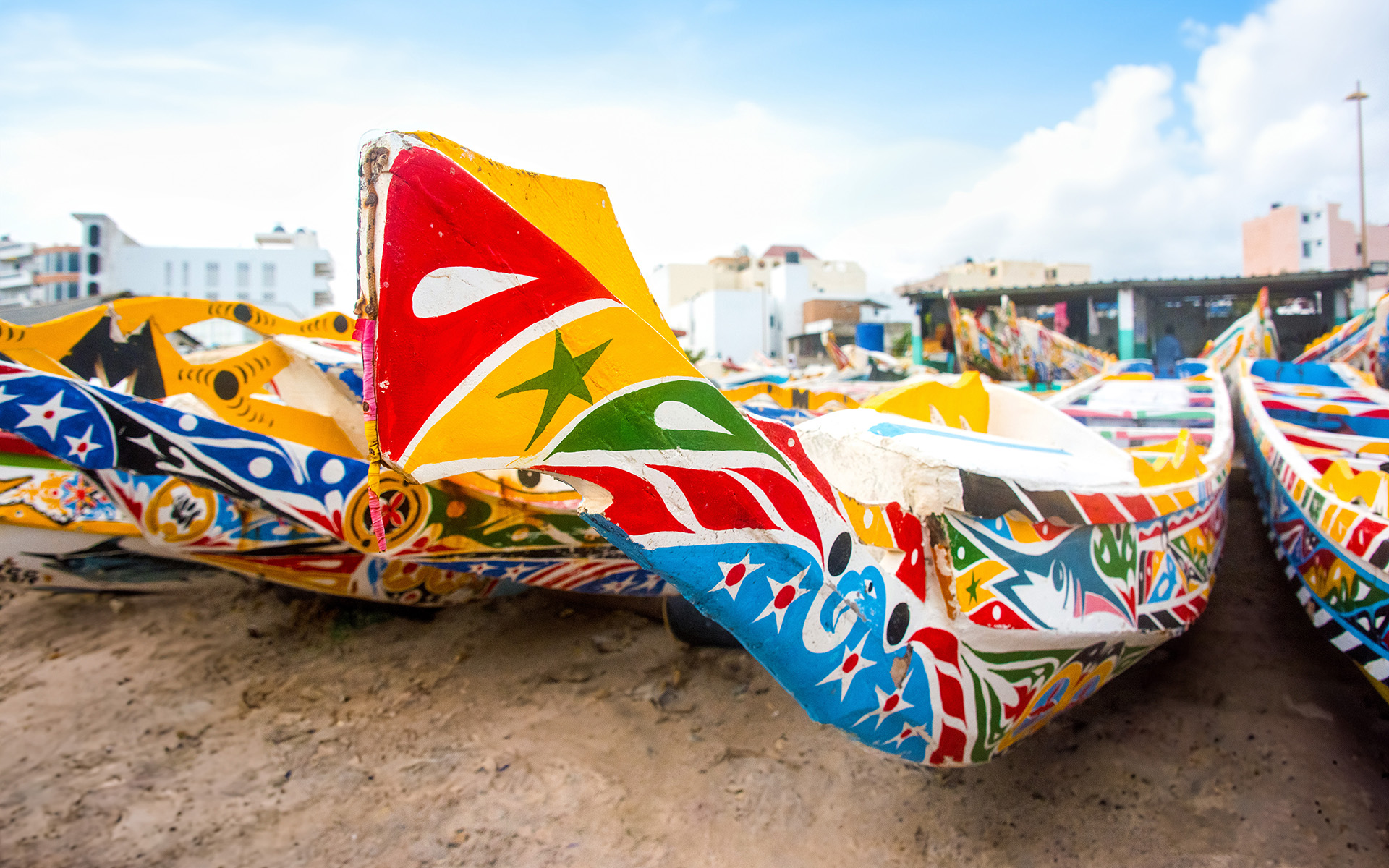 A colorfully painted canoe on the Dakar beach.