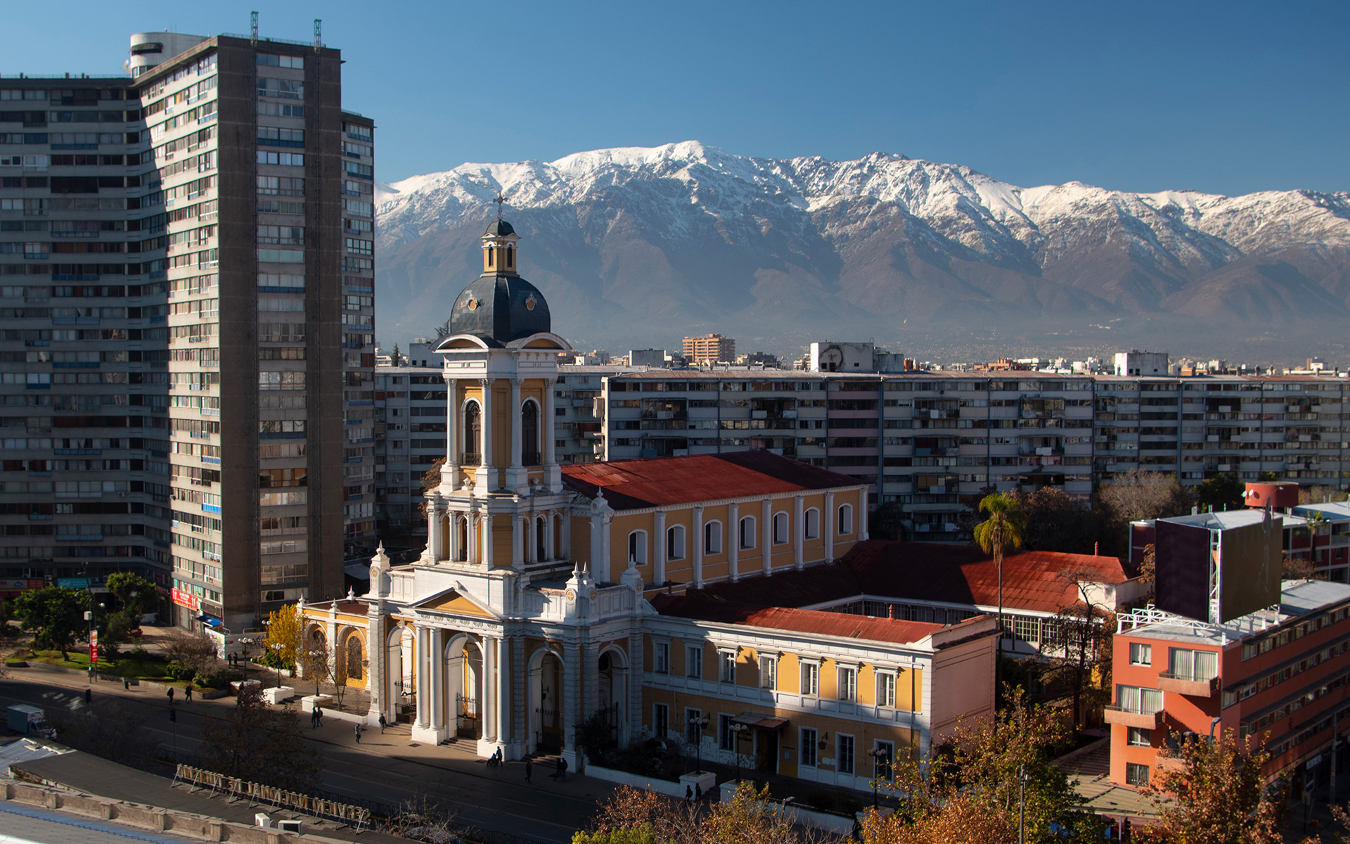 Santiago Community Church against a backdrop of mountain ranges.