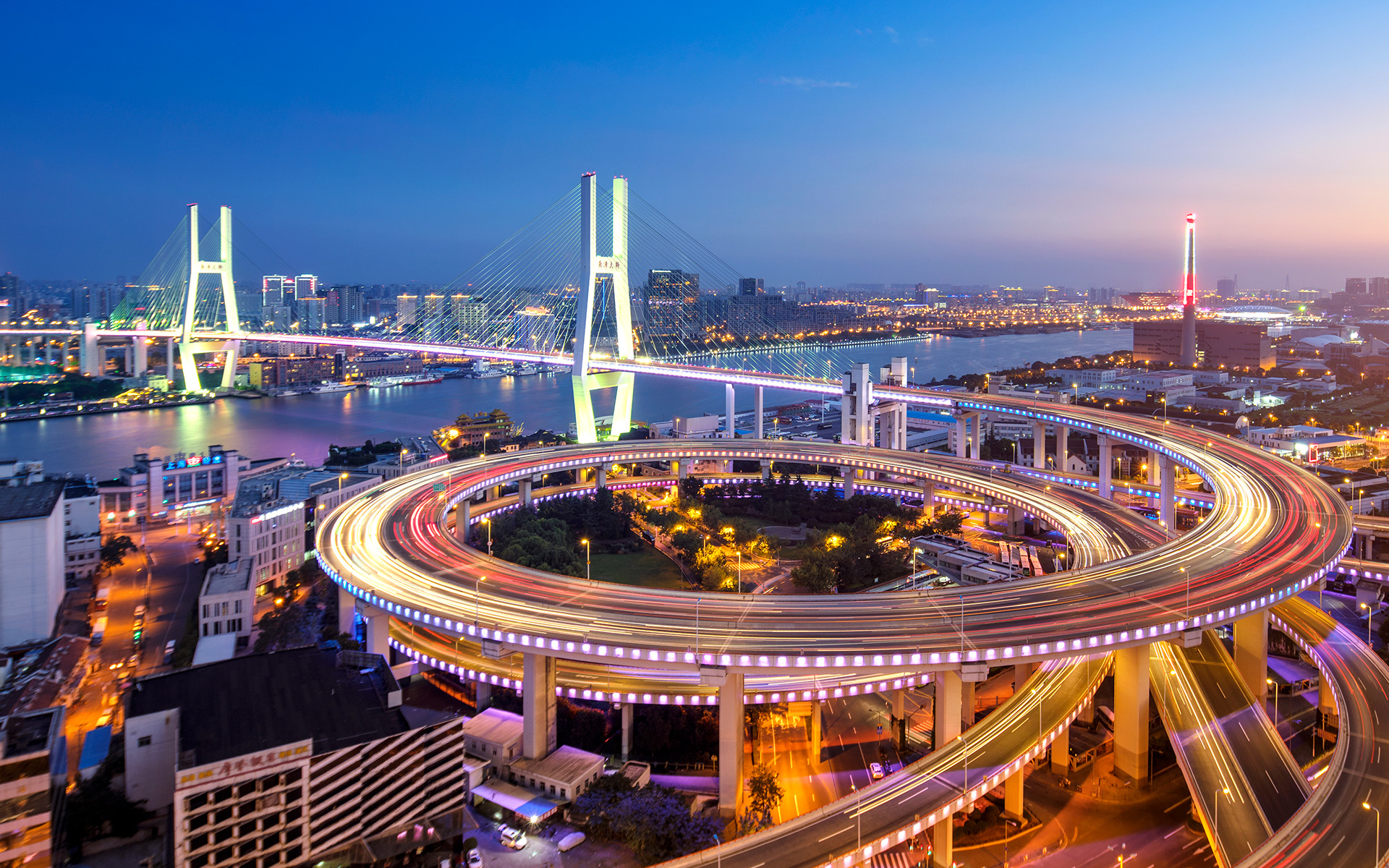 A circular highway network backdropped by the Nanpu Bridge.