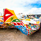 A colorfully painted canoe on the Dakar beach.