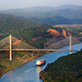 A cargo ship passing under a bridge in Panama City.