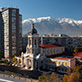 Santiago Community Church against a backdrop of mountain ranges.